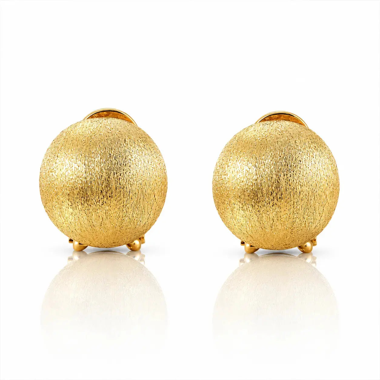 A pair of gold textured spherical stud earrings with small gold post backs, displayed on a clean white reflective surface.