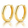 A pair of polished yellow gold hoop earrings shown on a clean white background with a soft reflection below.