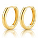 A pair of polished yellow gold hoop earrings shown on a clean white background with a soft reflection below.