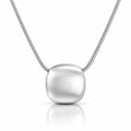 A silver pendant necklace featuring a brushed, rounded square pendant suspended from a delicate silver chain, set against a clean white background with a soft reflection below.