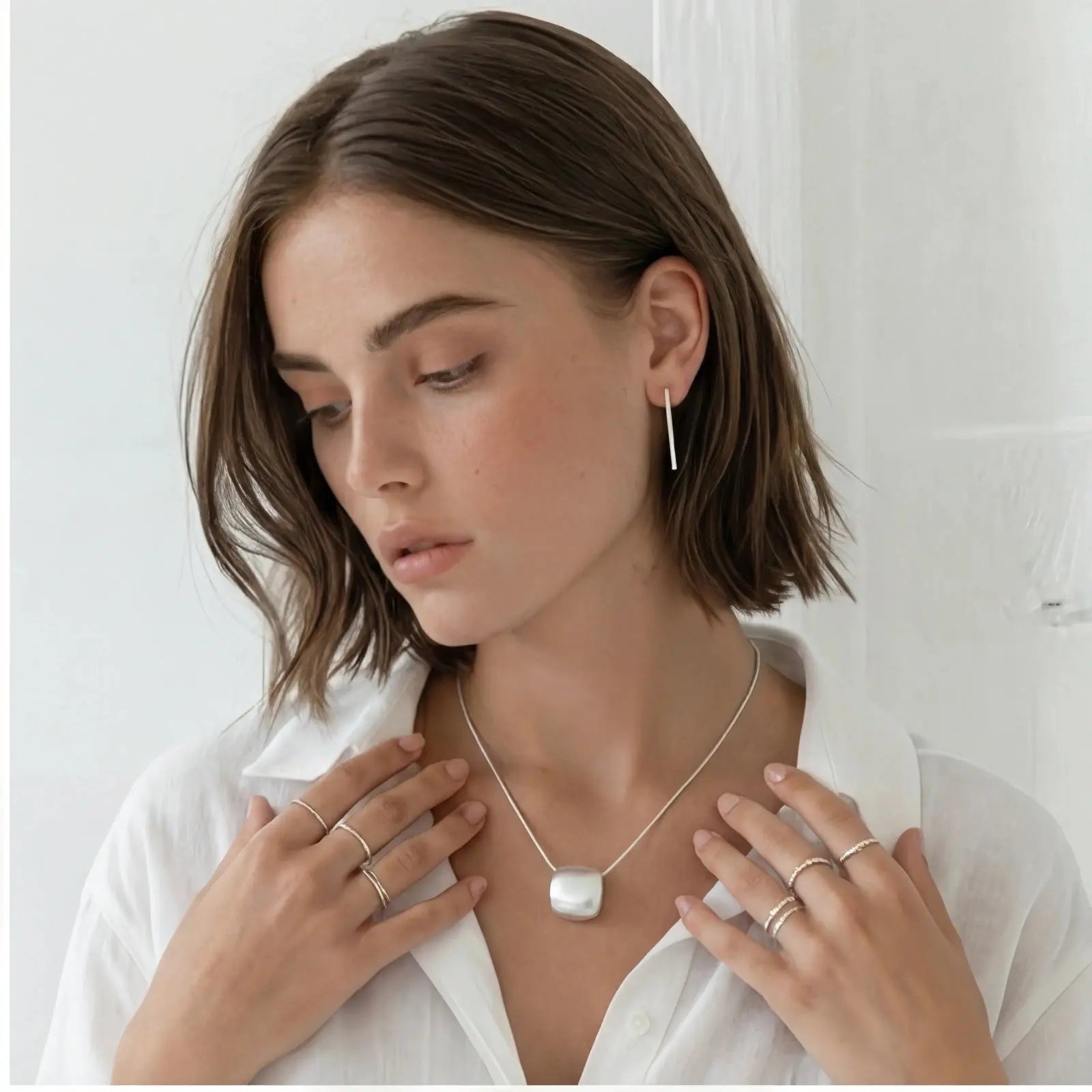 Woman wearing a necklace with a white background