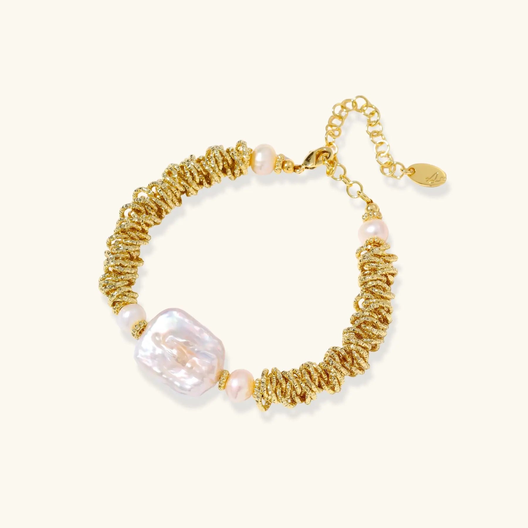 Gold and pearl bracelet on a white background