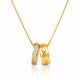 A gold pendant necklace featuring two interlocking bands: one with a row of clear stones and the other with an X-shaped cutout pattern, suspended on a gold chain against a white background.