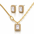 Gold jewelry set with emerald-cut gemstones on a white background