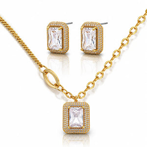 Gold jewelry set with emerald-cut gemstones on a white background