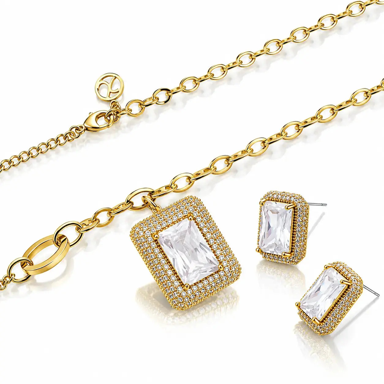 Gold-tone jewelry set featuring a rectangular pendant necklace, matching stud earrings, and a chain with an adjustable clasp, all decorated with clear crystals on a white background.
