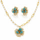 Gold-tone jewelry set with a pearl-and-link chain necklace, matching stud earrings, and a flower-shaped pendant. The flowers are accented with turquoise blue stones and pavé-set clear stones on a white background.