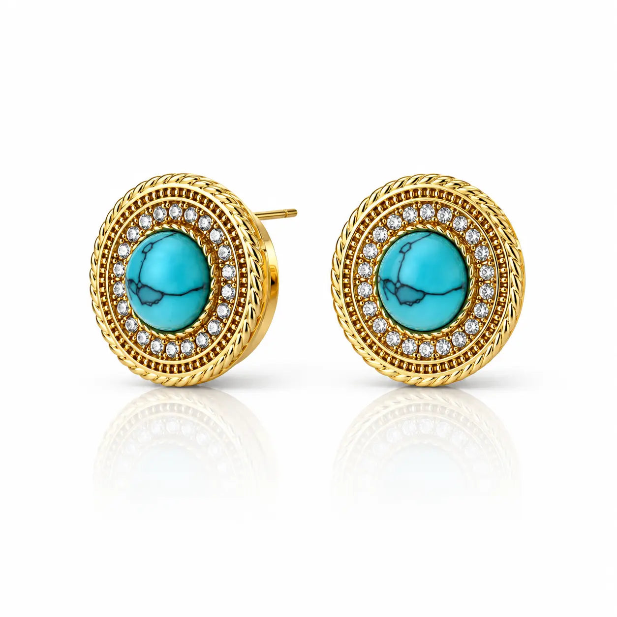 A pair of gold round stud earrings featuring a central turquoise stone surrounded by a halo of small clear stones and a textured gold border, shown on a white background with a soft reflection.