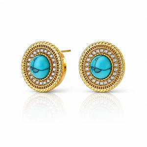 A pair of gold round stud earrings featuring a central turquoise stone surrounded by a halo of small clear stones and a textured gold border, shown on a white background with a soft reflection.