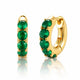 Gold hoop earrings with green gemstones on a white background