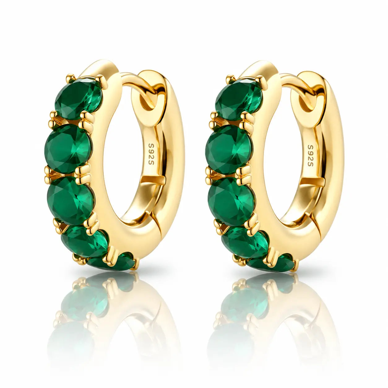 Gold hoop earrings with green gemstones on a white background