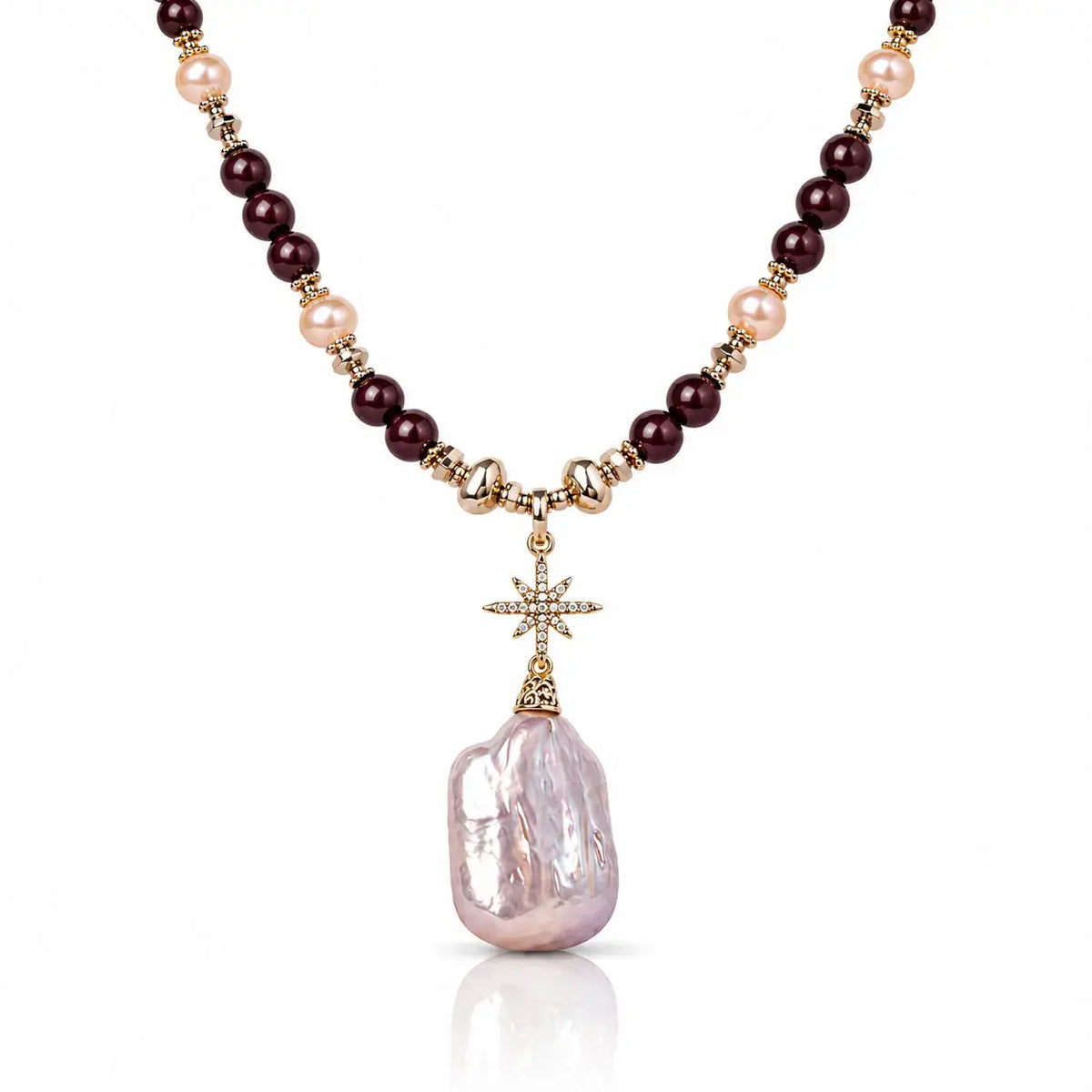 A beaded necklace featuring dark burgundy beads, light pink pearls, and gold-toned spacer beads, with a gold cross charm holding a large, irregular light pink baroque pearl pendant, shown on a white background.