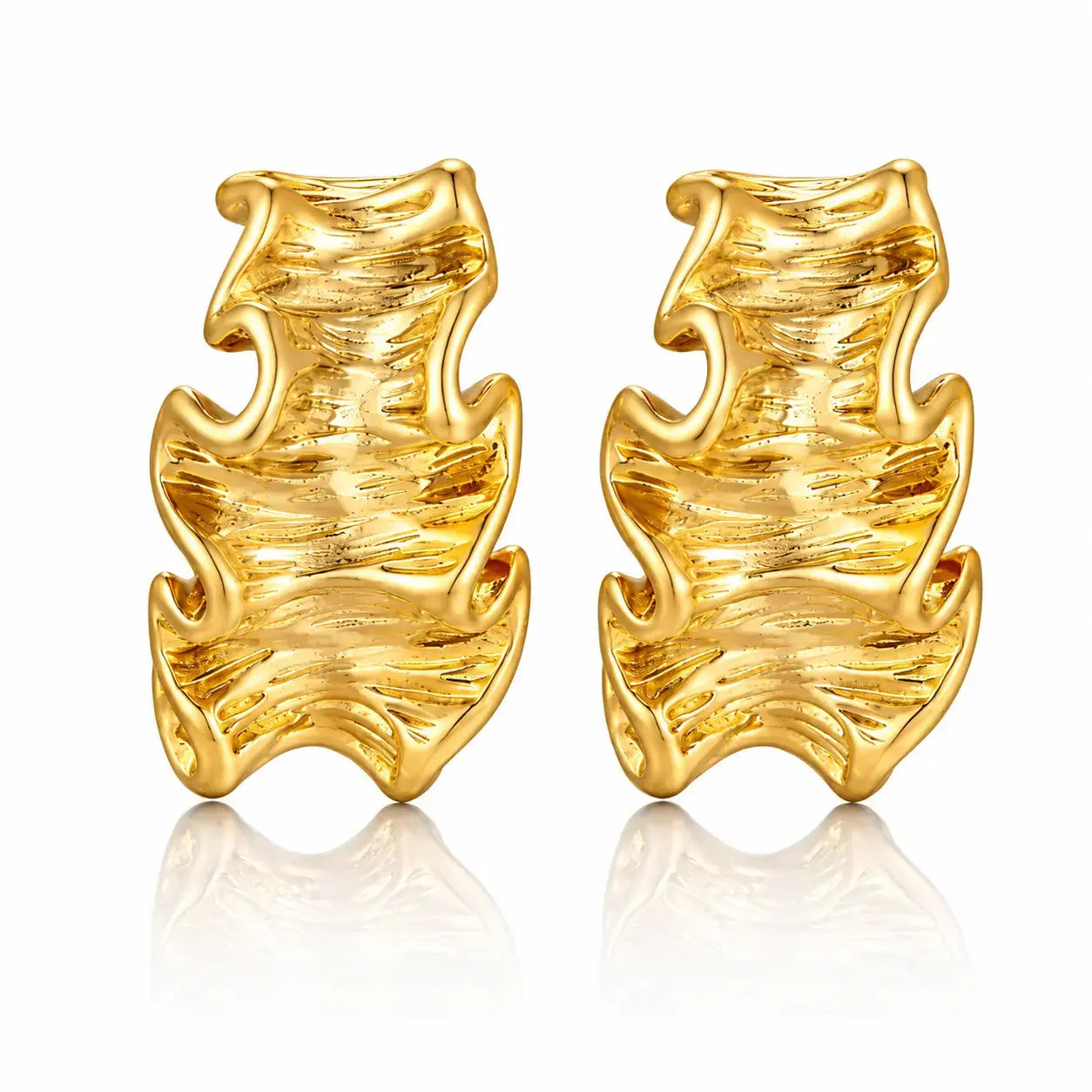 A pair of textured gold huggie hoop earrings with a wavy, organic flame-like design, displayed on a clean white background with a soft reflection below.