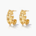 Pair of 18K gold plated wave design hoop earrings with textured surface on white background