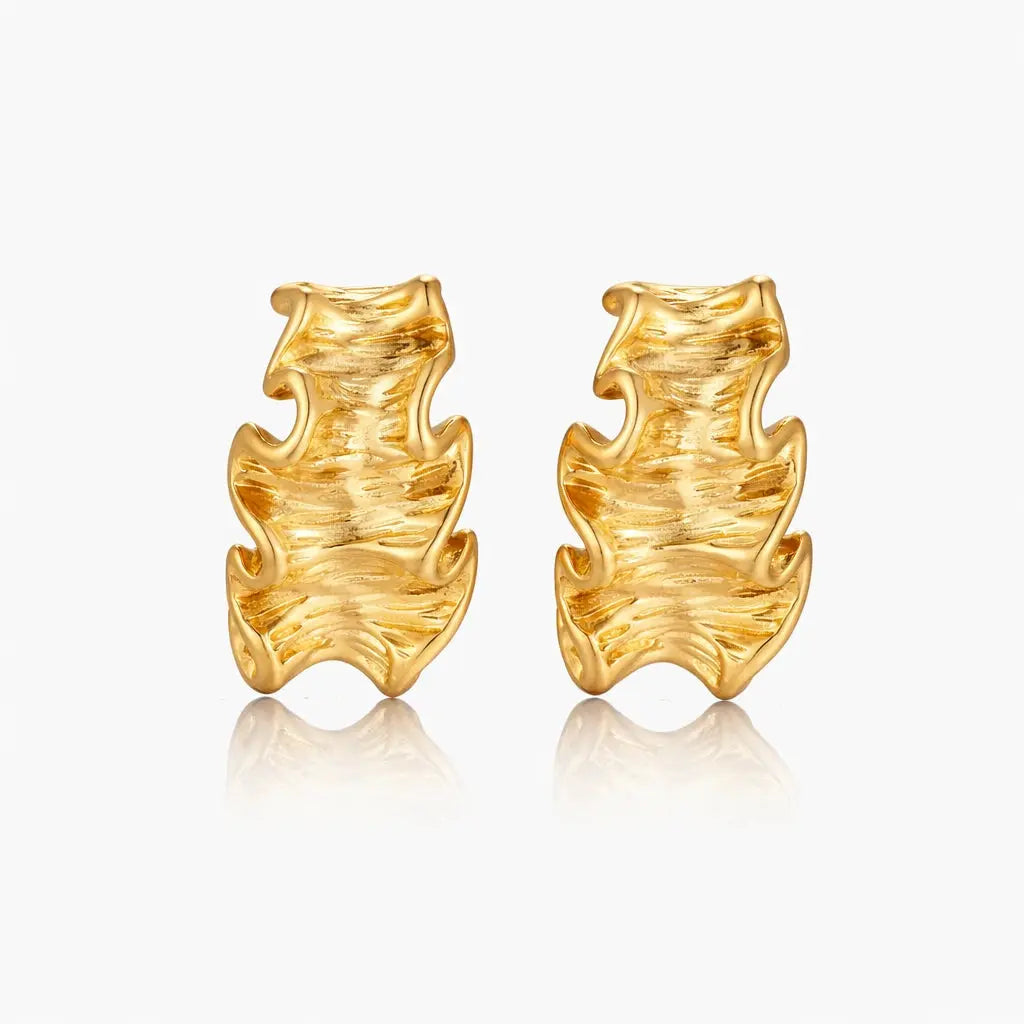 Pair of 18K gold plated wave textured hoop earrings on white background