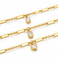 Three gold chain bracelets with rectangular bar links, each featuring a clear gemstone charm in a different shape: oval, emerald, and heart, displayed on a white background.