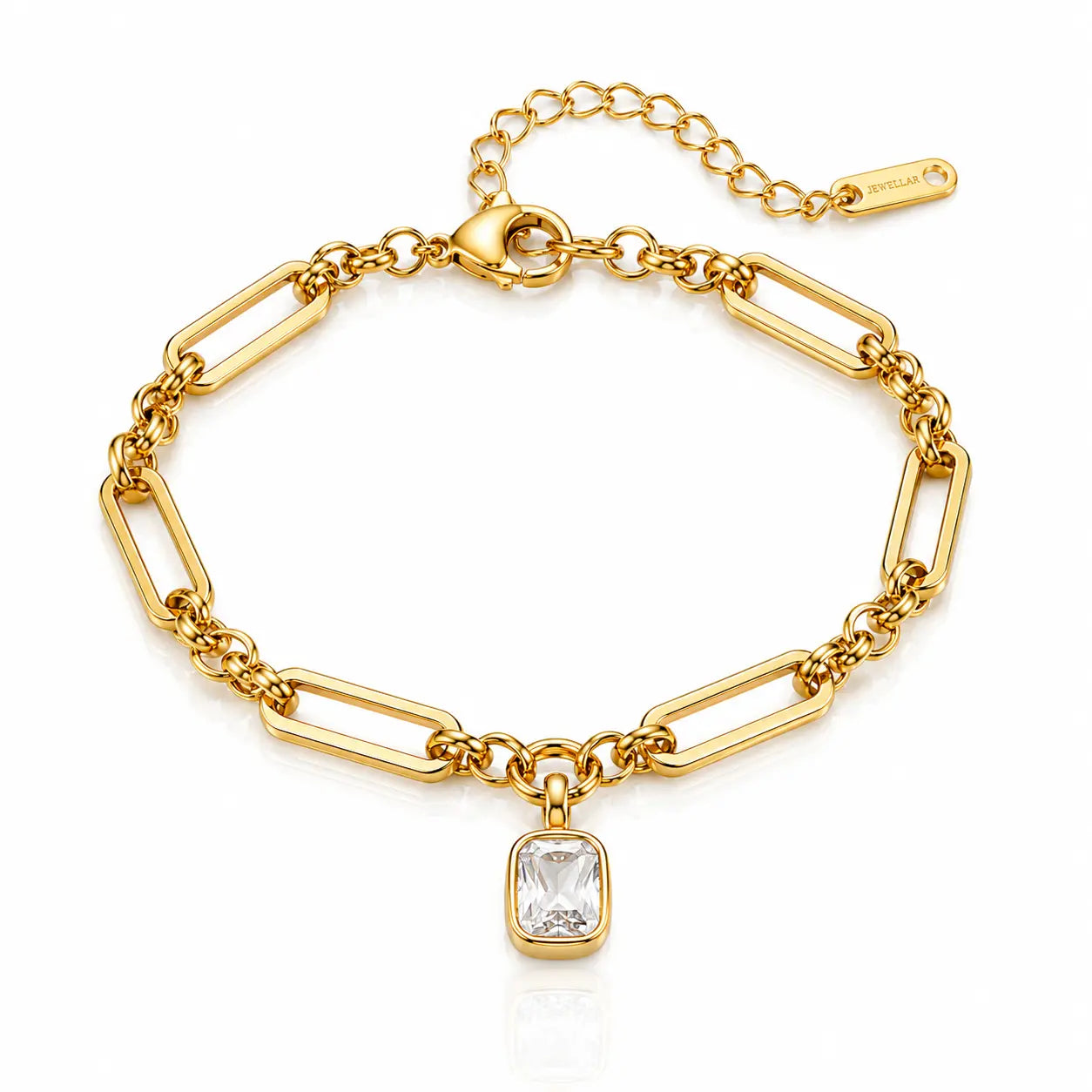 A gold paperclip chain bracelet with a rectangular clear gemstone pendant, displayed on a clean white background with a subtle reflection.
