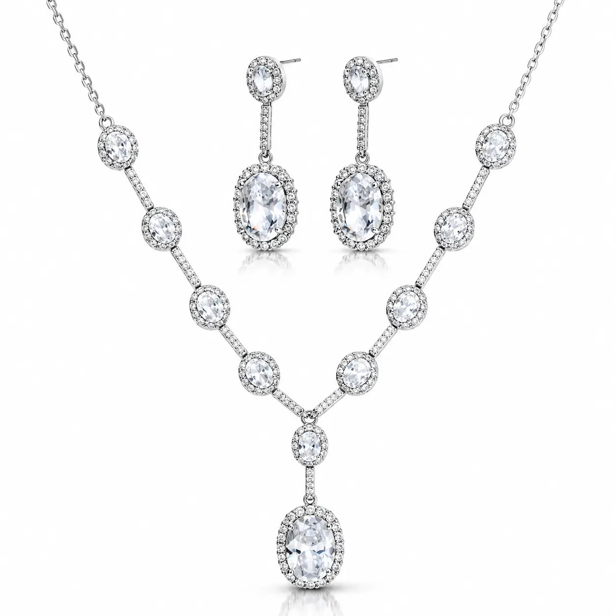 A silver-tone jewelry set featuring a V-shaped necklace and matching drop earrings, both adorned with clear round and oval gemstones, shown on a plain white background.