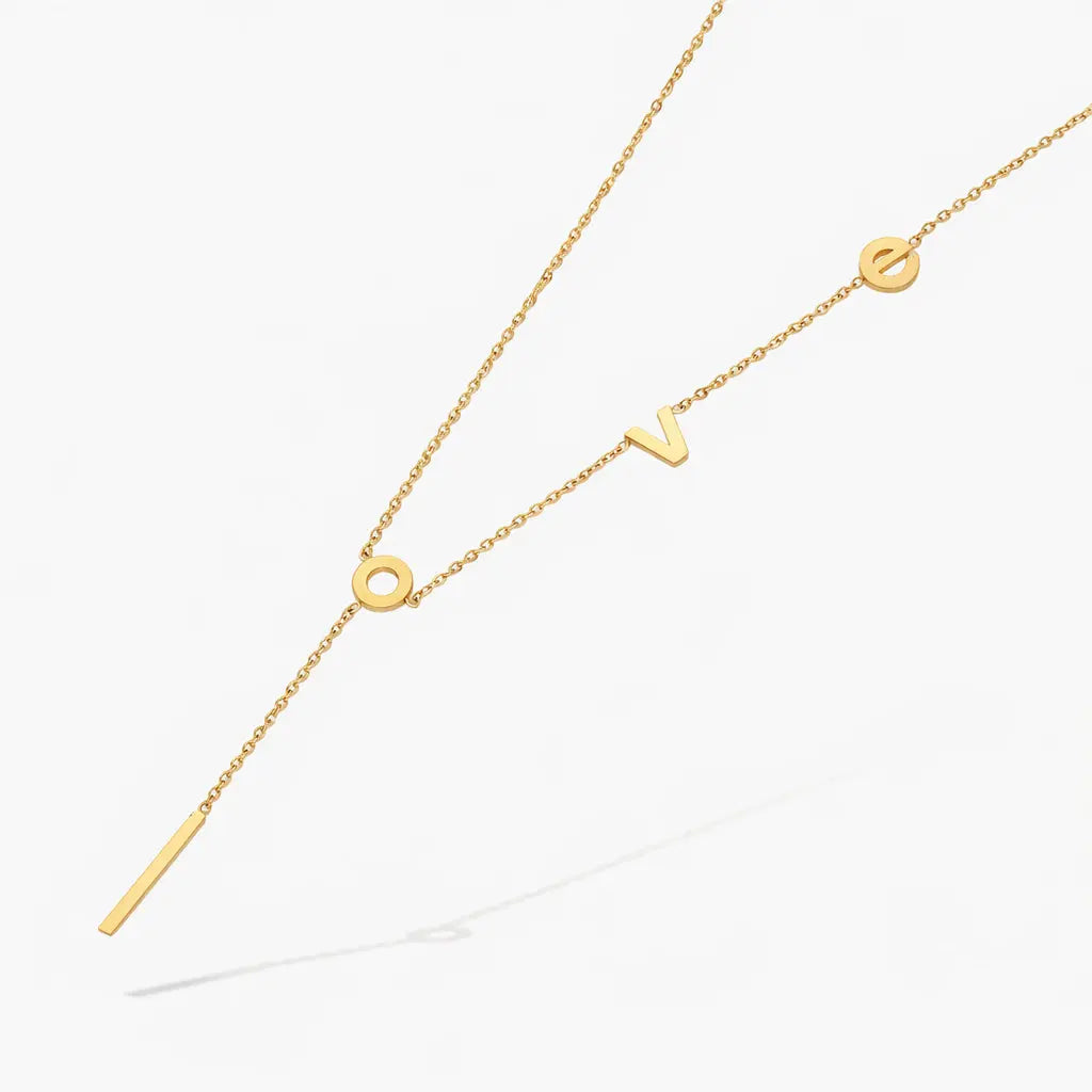 Gold love letter necklace with modern chain, minimalist jewelry on white background
