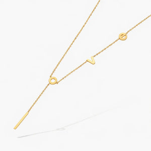 Gold love letter necklace with modern chain, minimalist jewelry on white background