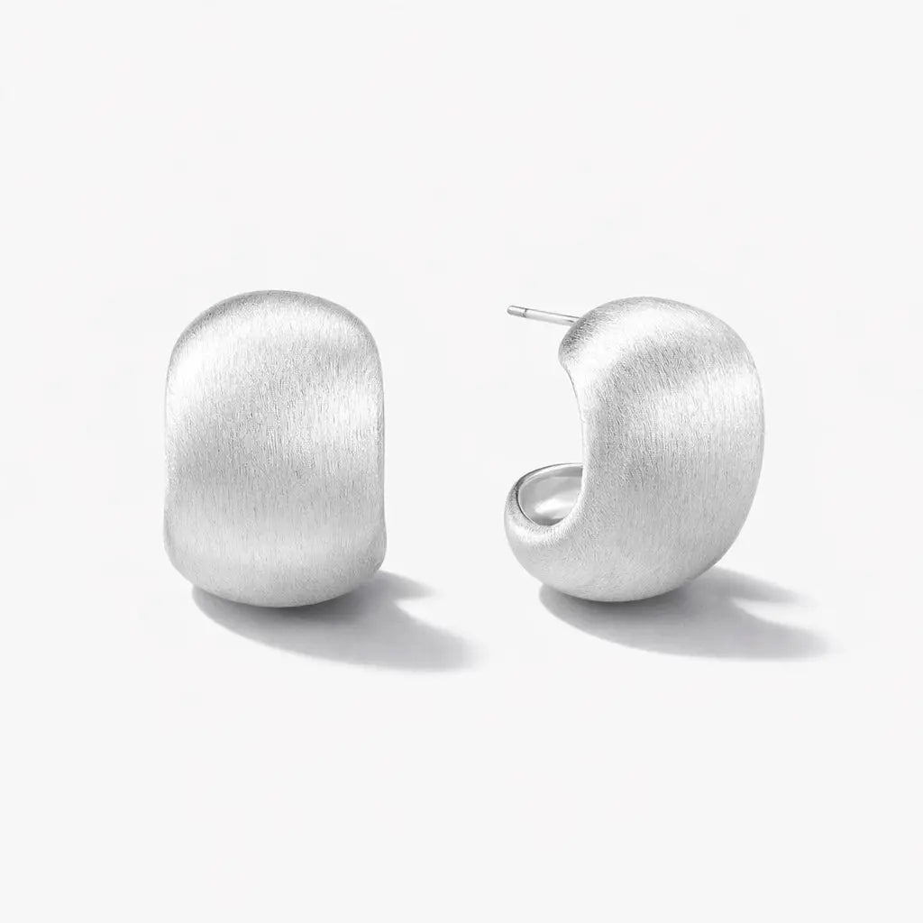 Brushed silver curve stud hoop earrings on white background, minimalist jewelry design