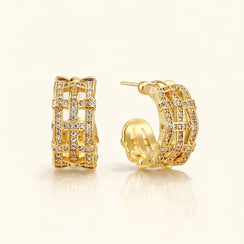 Gold hoop earrings with diamond accents on a white background