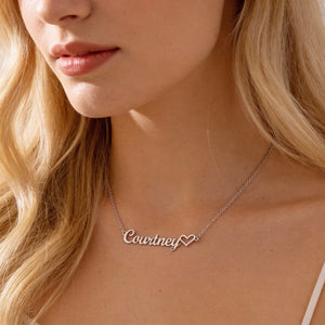 Close-up of a woman wearing a 'Courtney' necklace with a heart detail.
