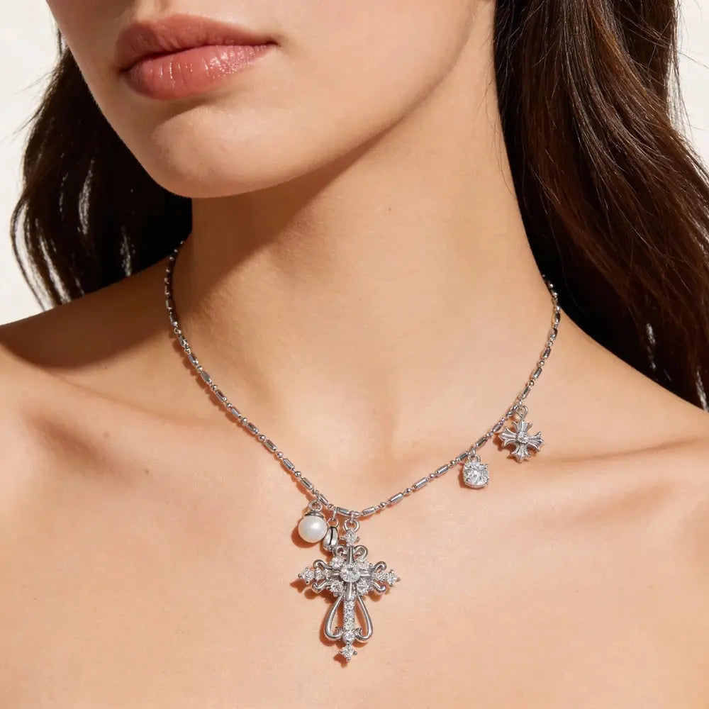 Silver necklace with a cross pendant worn by a model