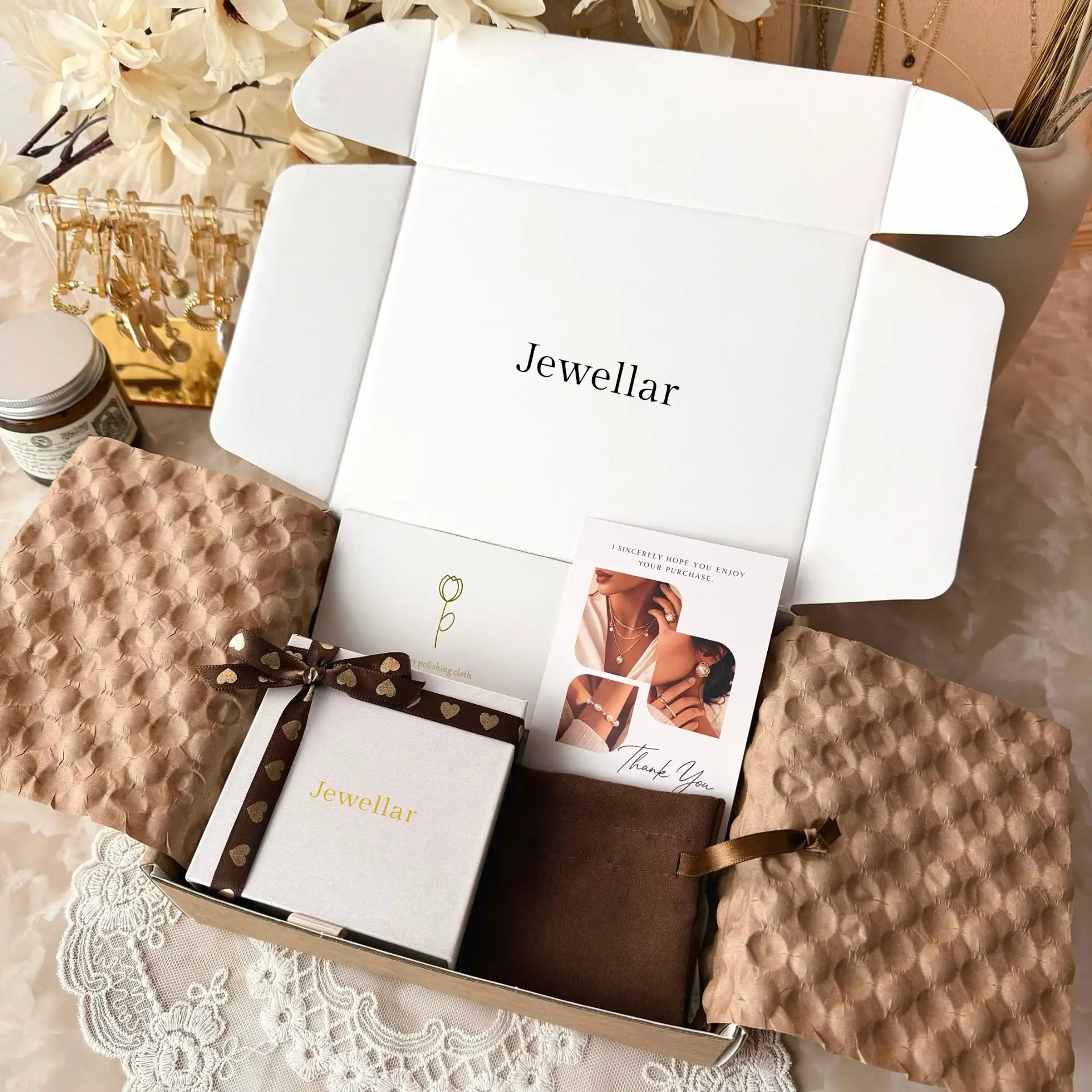 Gift box with jewelry and stationery items on a lace tablecloth