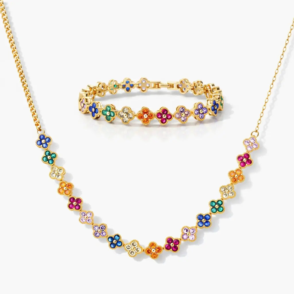 Gold necklace and bracelet set with colorful flower charms on a white background